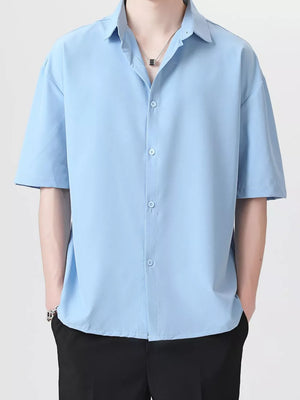 Men's light blue short-sleeve button-down shirt with a relaxed fit and spread collar.