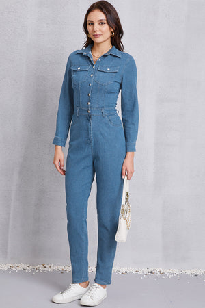 Denim utility jumpsuit in medium wash with defined waist, button front, and chest pockets.