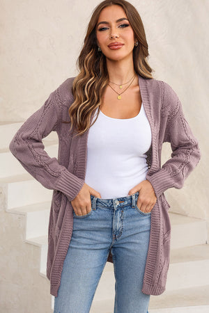 Lilac cable knit open-front cardigan with pockets and ribbed cuffs.
