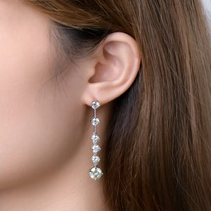Silver cascading diamond drop earrings with five brilliant stones.