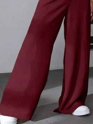 Burgundy high-waisted pleated wide-leg maternity trousers with a casual flowy fit.