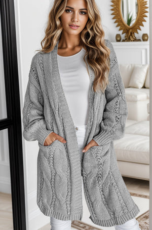 Light gray cable knit open-front cardigan with pockets and intricate stitch details.