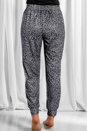 Jogger trousers in dark gray with a black leopard print and elastic waistband.