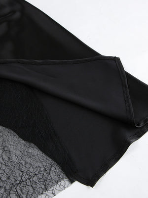Black midi skirt with sheer lace panel detail and asymmetrical hem.