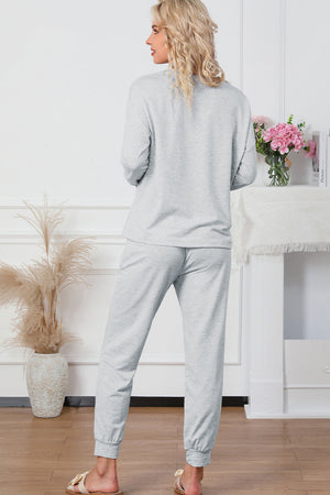 Plush lounge set in light gray, relaxed fit joggers with cuffed ankles.