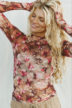 Sheer floral mock neck top with long sleeves and a second-skin fit.