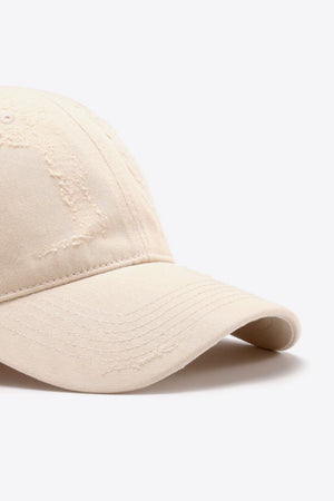 Cream baseball cap with distressed details and stitched brim