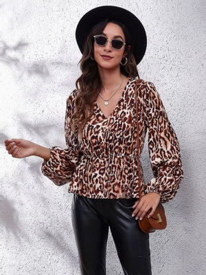 Leopard peplum blouse with gathered waist, V-neck, and balloon sleeves.