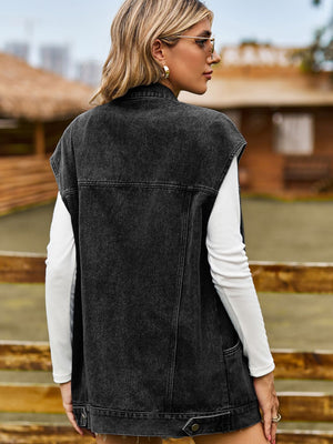 Black oversized denim sleeveless jacket with button details and pockets.