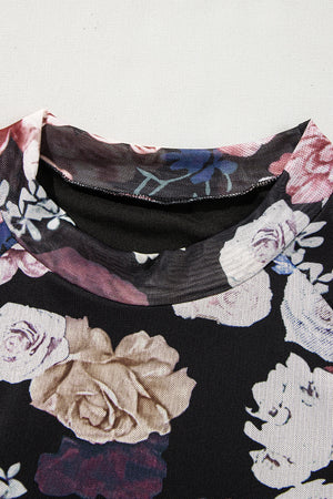 Black mesh blouse with romantic floral print and mock neck detail.