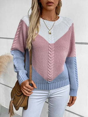 Chevron cable knit sweater in pastel blue and blush pink colorblock with white accents.