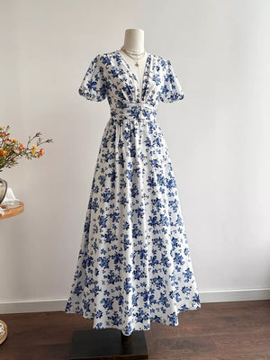 Delightful floral v-neck maxi dress with cinched waist and short sleeves.