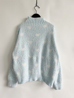 Mint blue acrylic turtleneck sweater with allover white heart motif and textured knit.