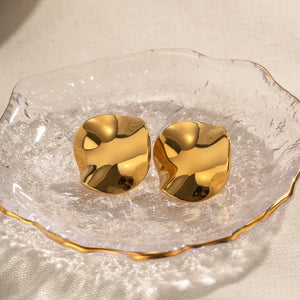 Sculpted gold wave stud earrings with a polished finish.