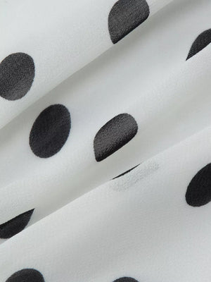White mini dress with black polka dots and ruched detail