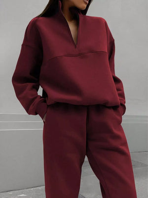 Burgundy half zip sweatshirt and matching pants set with a deep V-neckline.