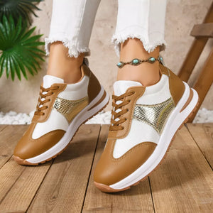 Chic lace-up sneakers in light brown and white with textured gold accents.