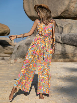 Bohemian floral tie-strap jumpsuit with wide legs and a cinched waist.