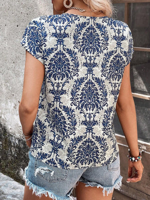 Blue damask print short sleeve blouse with keyhole neckline.