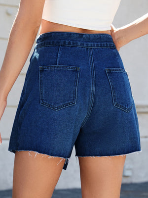 Dark wash denim skort with asymmetric wrap detail and raw hem