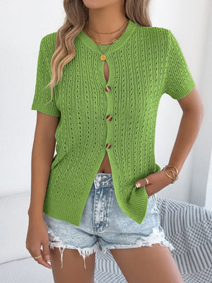 Green knit button-up cardigan with short sleeves and a textured open knit.