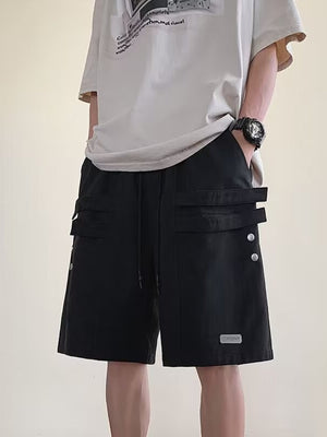 Men's black cargo shorts with drawstring and double strap pocket detail.