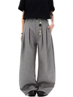 Men's grey wide-leg pleated sweatpants with a key chain detail.