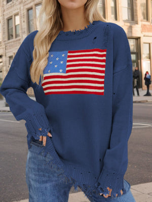 French blue knit sweater with frayed details and an American flag graphic.