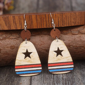 Wooden dangle earrings with star cutouts and red, white, and blue stripes.
