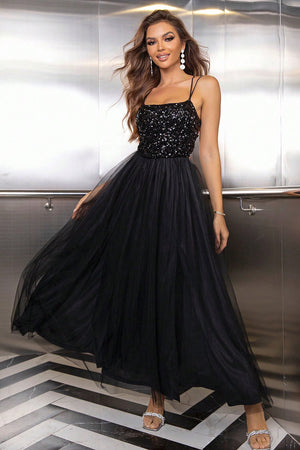 Black sequin bodice tulle maxi dress with spaghetti straps and a flowing skirt.