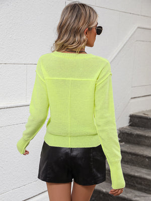 Relaxed fit v-neck knit sweater in yellow-green with long sleeves and ribbed cuffs.
