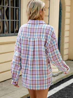 Long sleeve collared plaid shirt in pastel purple, blue, and white with button cuffs.