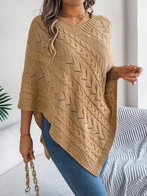 Camel cable knit poncho with chevron detail and v-neck, styled with jeans.