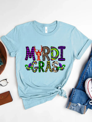 Light blue graphic tee with Mardi Gras text in mixed patterns and a crawfish graphic.