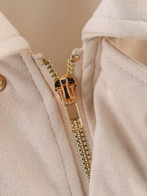 Oversized zip-up jacket in off-white with a gold zipper detail.