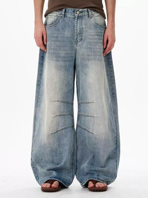 Men's light wash denim wide leg jeans with faded details and relaxed fit.
