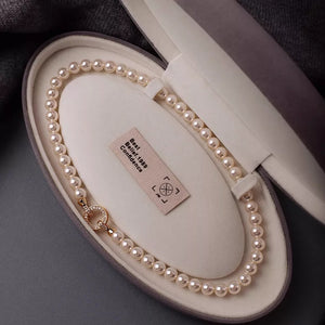 Cream pearl choker necklace with 18k gold clasp in jewelry box