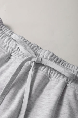 Light gray French terry skort with drawstring and elastic waistband detail.