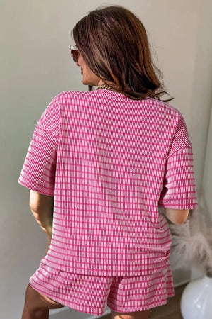 Fuchsia pink striped two-piece short set with drawstring shorts and short-sleeve top.