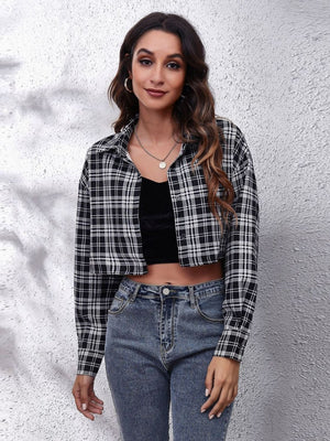 Checkerboard cropped shirt jacket in black and white plaid, buttoned with collar.
