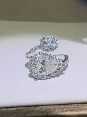 Silver bypass ring with pear and princess cut halo diamonds