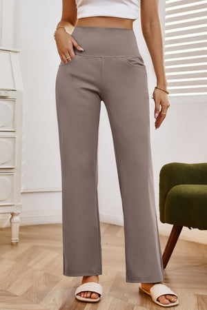 High-waisted flare leg trousers in tan with pockets, styled casually.
