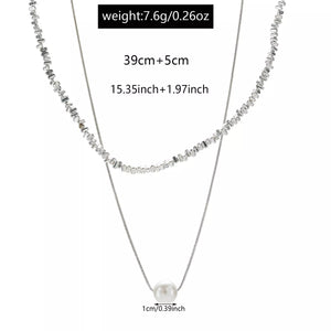 Silver double layered necklace with pearl accent and textured chain detail