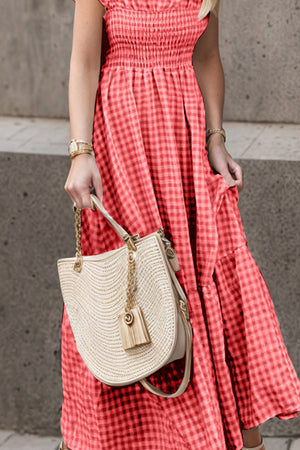 Smocked gingham maxi dress with flutter sleeves and tiered hem in coral.