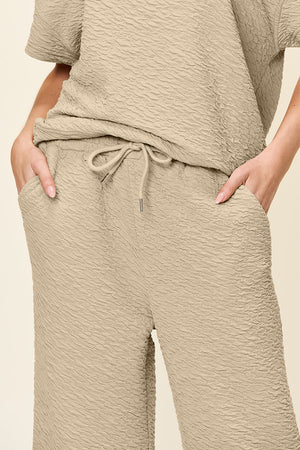 Textured cocoon top and wide leg pants set in khaki with drawstring waist and pockets.