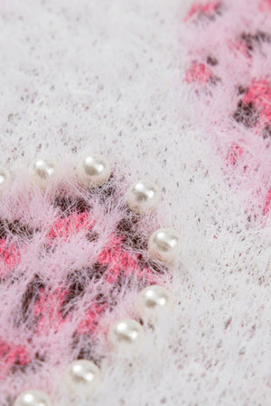 Fuzzy knit sweater in blush pink with jacquard heart pattern and pearl embellishments.