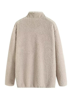 Beige sherpa zip-up jacket with stand collar and long sleeves.