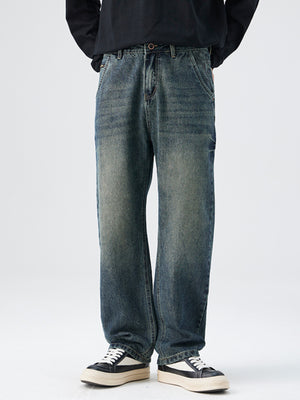 Men's relaxed fit vintage wash denim jeans with distressed details.