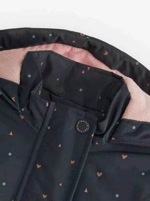 Toddler zip-up jacket with heart and dot pattern, pink fleece lining, and button detail.