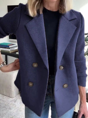 Dark blue double-breasted knit sleeve outerwear with button front and notched lapel.